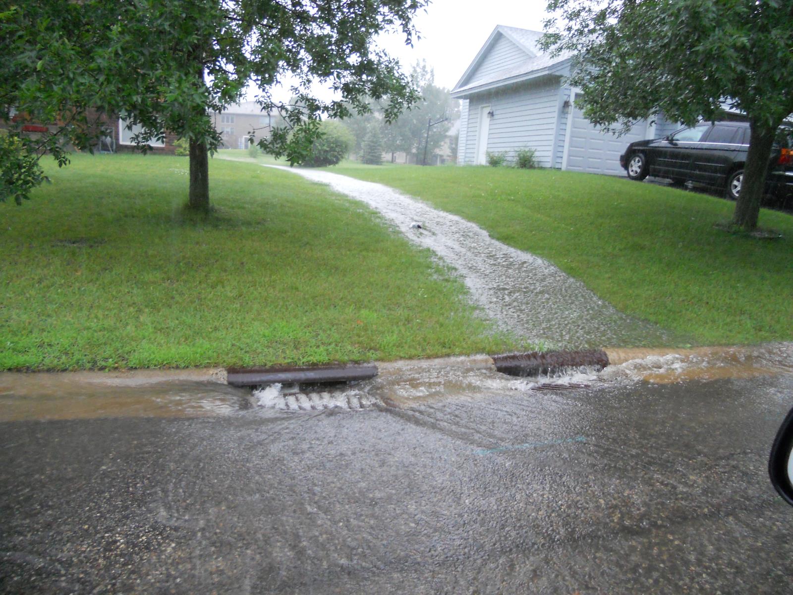 Rain water washing off the lawn and into a stormdrain